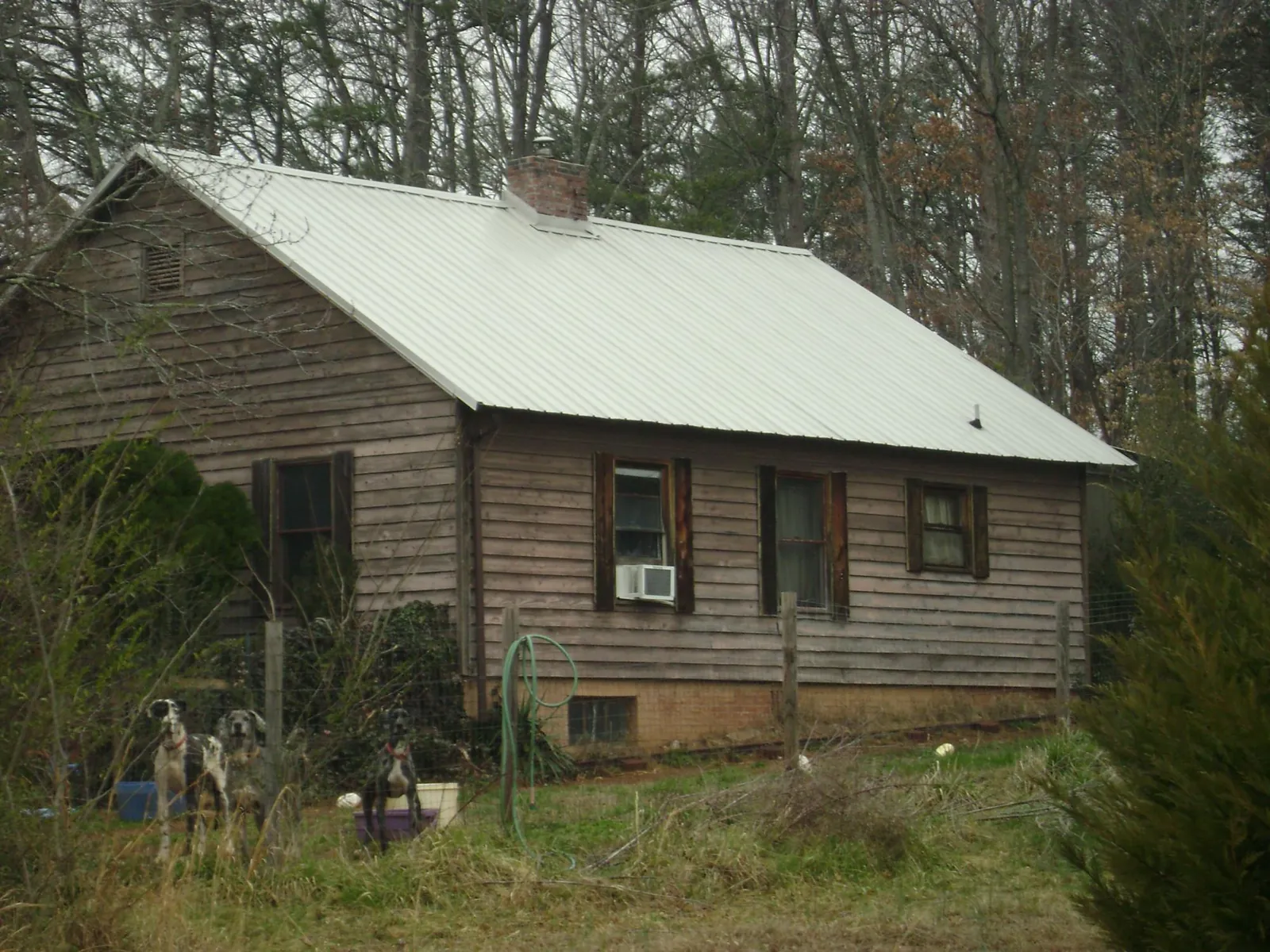 White metal roof on an old wood sided farmhouse, from a Metal Roof Installation job in Quantico